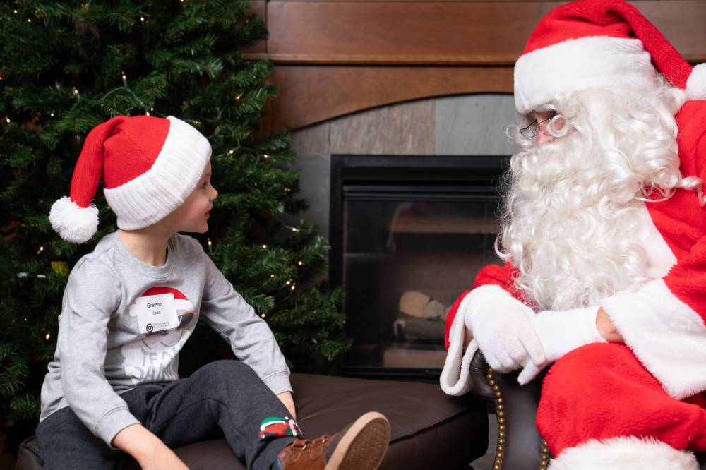 A kid talking to Santa.